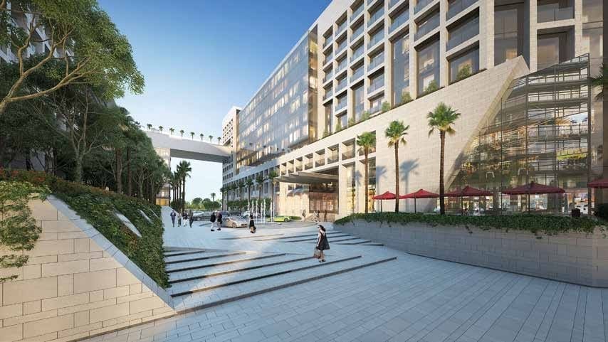 Aerial view of Park View residential complex showcasing two towers with connecting bridge and lush greenery in Abu Dhabi.